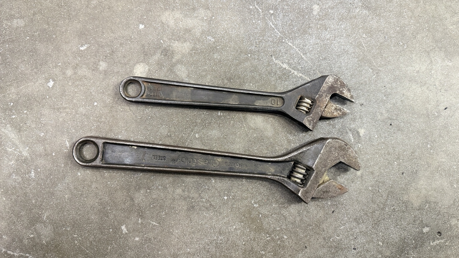 Two vintage adjustable wrenches before rust-removal treatment photograph