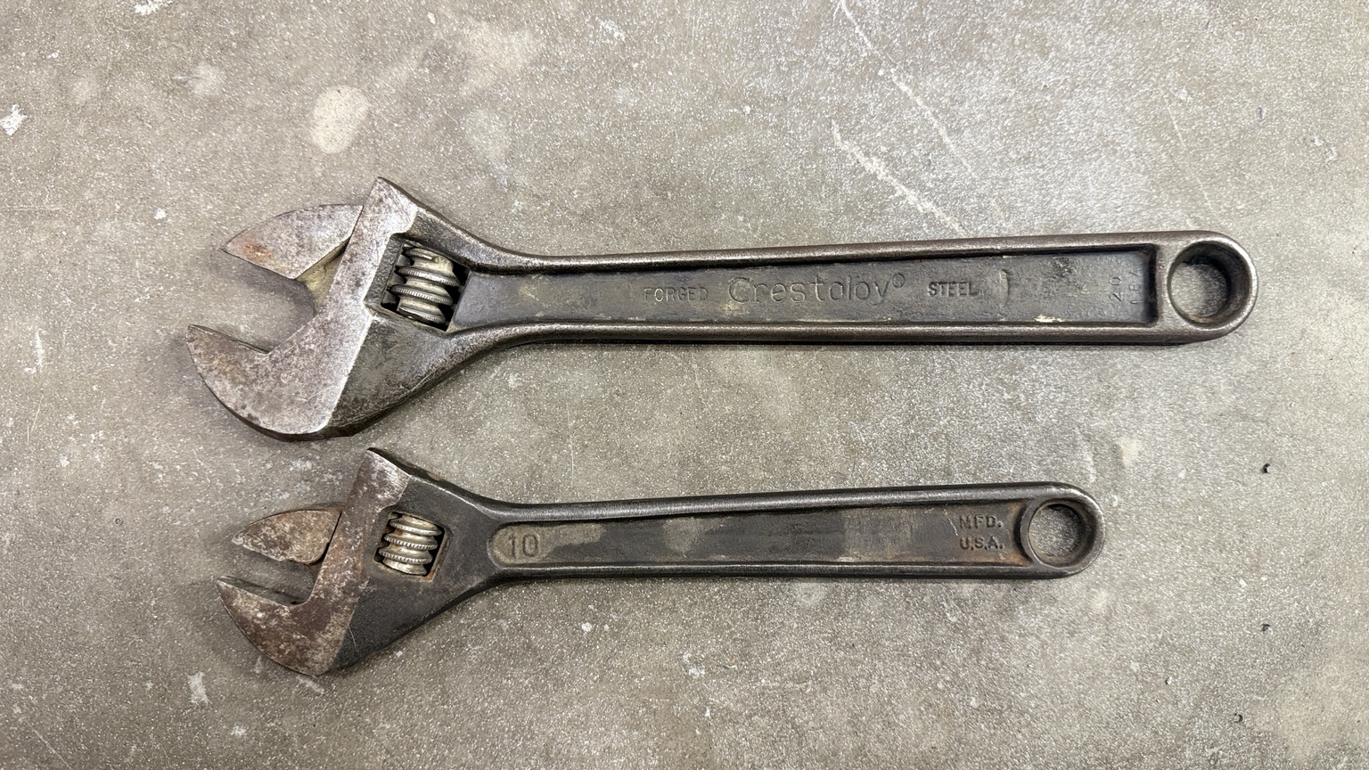 Two vintage adjustable wrenches before rust-removal treatment photograph