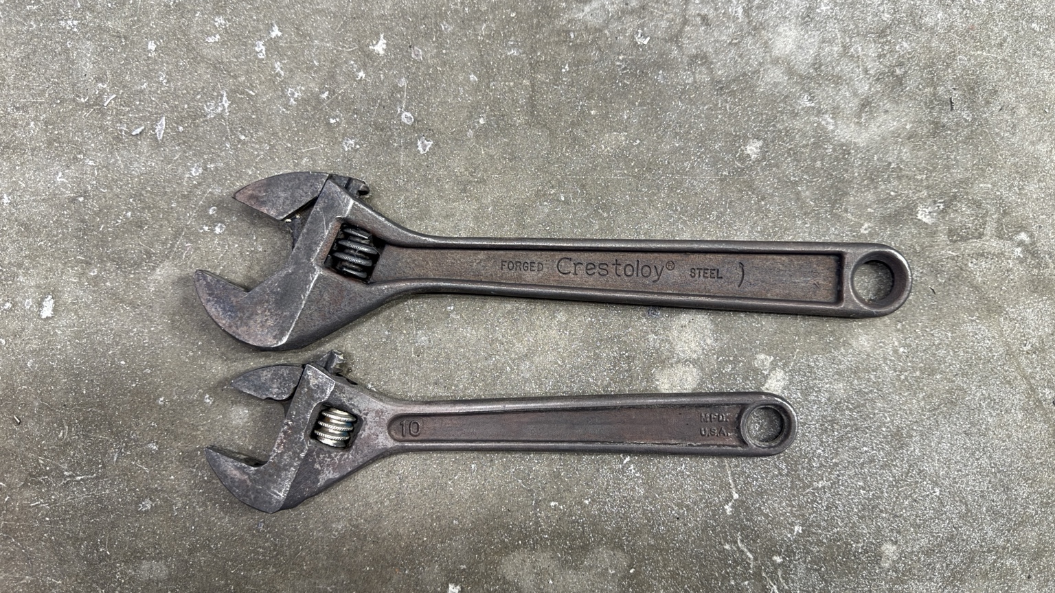 Two vintage adjustable wrenches after rust-removal treatment photograph